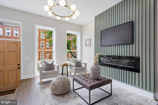 724 E 21st St, Baltimore, MD 21218 - living area with wood finished floors, a chandelier, and baseboards