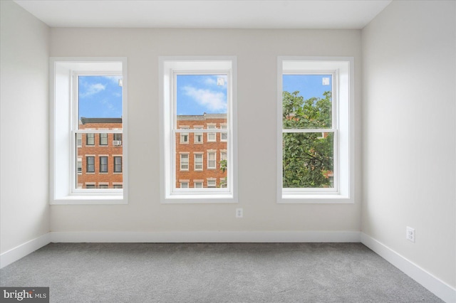 724 E 21st St, Baltimore, MD 21218 - spare room featuring carpet floors, healthy amount of natural light, and baseboards