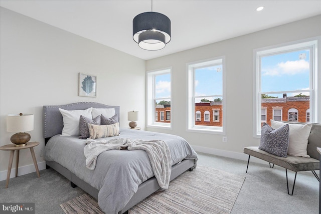 724 E 21st St, Baltimore, MD 21218 - bedroom with carpet flooring, baseboards, and multiple windows