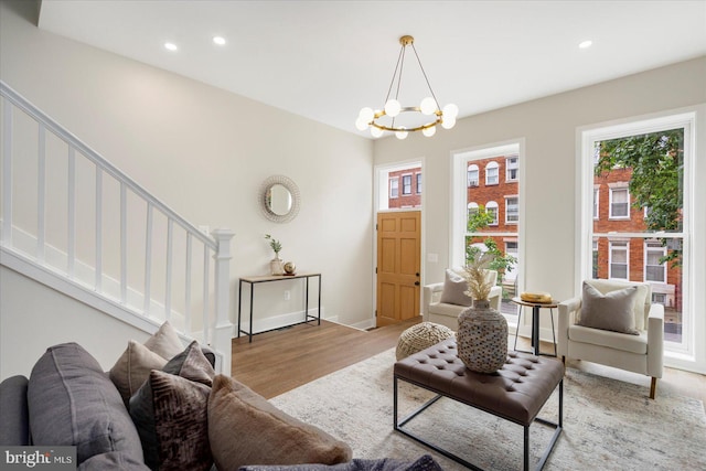 724 E 21st St, Baltimore, MD 21218 - living room featuring stairway, healthy amount of natural light, light wood-style flooring, recessed lighting, and a chandelier
