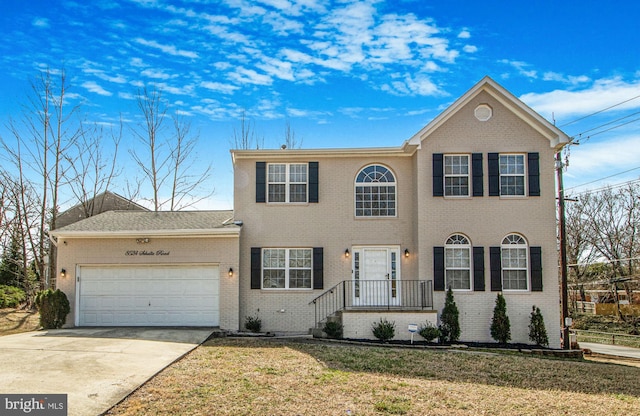 8524 Schultz Rd, Clinton, MD 20735 - colonial inspired home with brick siding, a garage, concrete driveway, and a front lawn