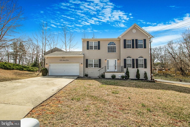8524 Schultz Rd, Clinton, MD 20735 - colonial inspired home with a garage, a front lawn, driveway, and stucco siding