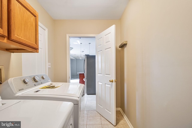 8524 Schultz Rd, Clinton, MD 20735 - laundry area with washer and dryer, cabinet space, light tile patterned floors, and baseboards