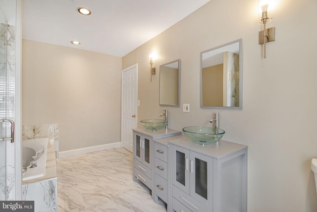 8524 Schultz Rd, Clinton, MD 20735 - full bathroom with marble look tiles, double vanity, a garden tub, recessed lighting, and baseboards