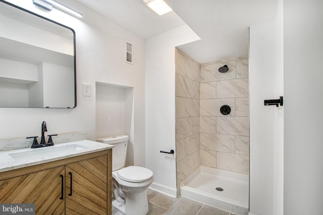 8524 Schultz Rd, Clinton, MD 20735 - bathroom featuring toilet, vanity, tile patterned flooring, baseboards, and a tile shower