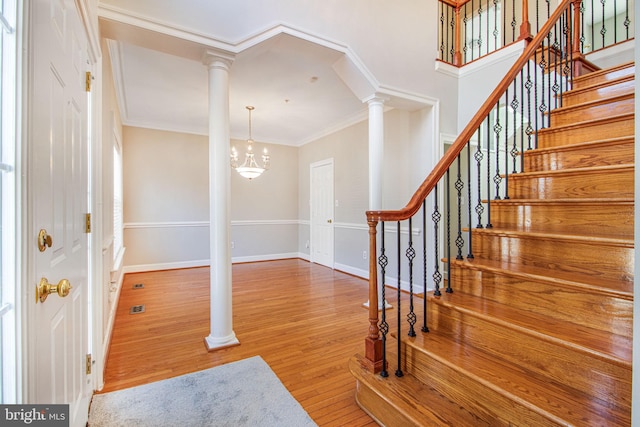 8524 Schultz Rd, Clinton, MD 20735 - foyer entrance with ornate columns, wood finished floors, ornamental molding, stairs, and a chandelier