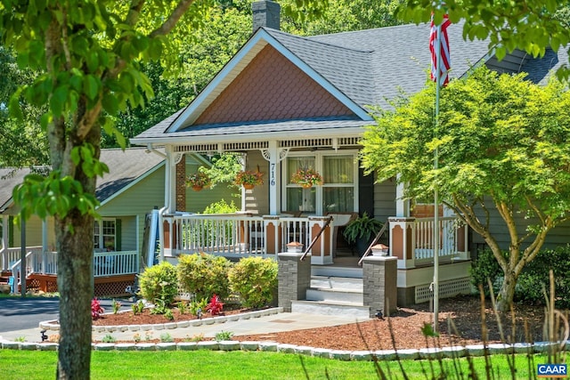 716 Preddy Creek Rd, Barboursville, VA 22923 - victorian-style house featuring a porch, a shingled roof, and a chimney