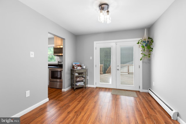 1704 Horner Rd, Woodbridge, VA 22191 - unfurnished dining area with a baseboard heating unit, french doors, wood finished floors, and baseboards