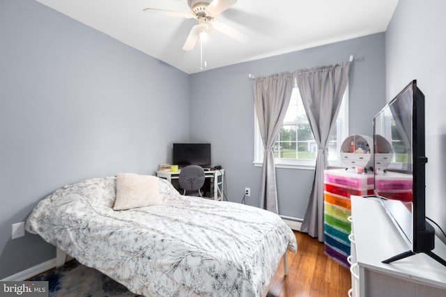 1704 Horner Rd, Woodbridge, VA 22191 - bedroom featuring a baseboard heating unit, wood finished floors, a ceiling fan, and a desk