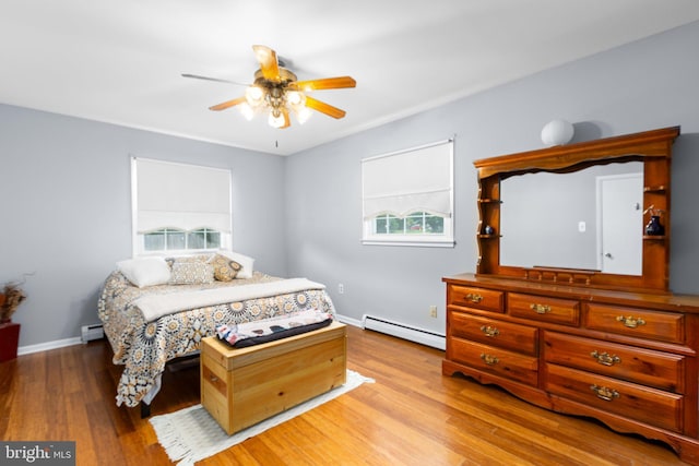 1704 Horner Rd, Woodbridge, VA 22191 - bedroom featuring baseboard heating, multiple windows, light wood finished floors, and baseboards