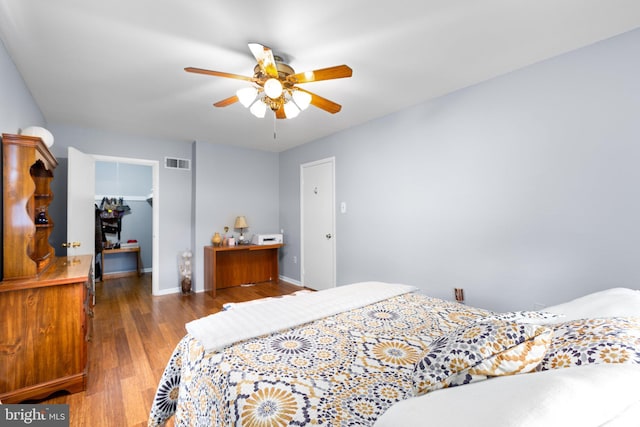 1704 Horner Rd, Woodbridge, VA 22191 - bedroom with wood finished floors, baseboards, a ceiling fan, and a walk in closet