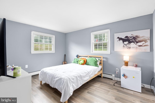1704 Horner Rd, Woodbridge, VA 22191 - bedroom featuring baseboard heating, a baseboard radiator, multiple windows, and wood finished floors