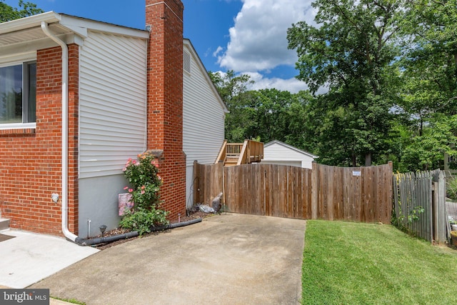 1704 Horner Rd, Woodbridge, VA 22191 - view of home's exterior with a chimney, a patio, and brick siding