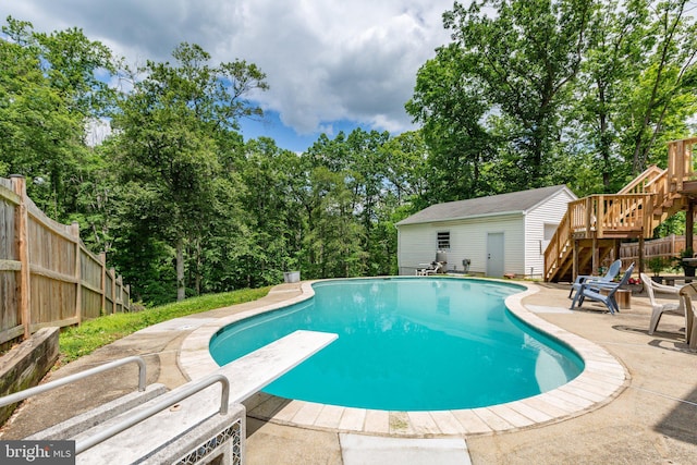 1704 Horner Rd, Woodbridge, VA 22191 - view of pool featuring stairway, a patio area, a diving board, view of scattered trees, and an outbuilding