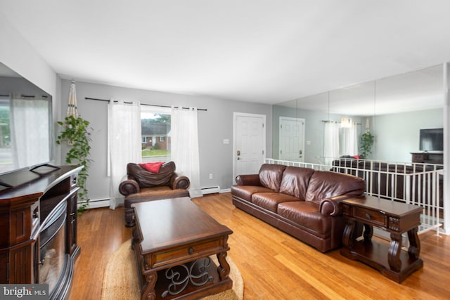 1704 Horner Rd, Woodbridge, VA 22191 - living room with light wood finished floors, a baseboard heating unit, baseboards, and baseboard heating
