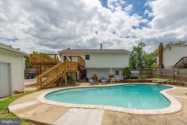 1704 Horner Rd, Woodbridge, VA 22191 - view of pool with stairs, a wooden deck, a fenced backyard, and a patio
