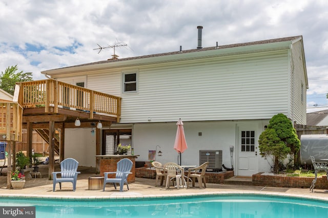 1704 Horner Rd, Woodbridge, VA 22191 - back of property with cooling unit, an outdoor pool, a wooden deck, and a patio