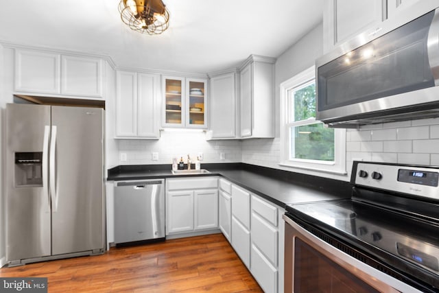 1704 Horner Rd, Woodbridge, VA 22191 - kitchen with appliances with stainless steel finishes, a sink, dark countertops, and white cabinets