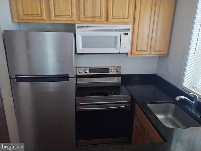 4202 Grant St NE Unit 202, Washington, DC 20019 - kitchen featuring appliances with stainless steel finishes, a sink, dark countertops, and light brown cabinetry