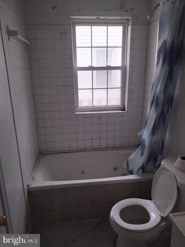4202 Grant St NE Unit 202, Washington, DC 20019 - full bathroom featuring a combined bath / shower with jetted tub, toilet, and marble look tiles