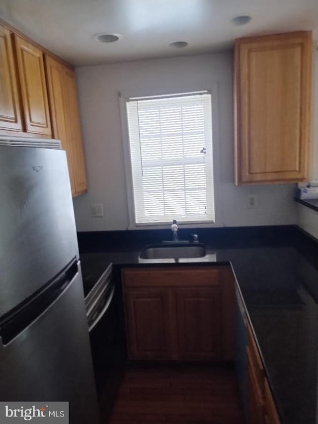 4202 Grant St NE Unit 202, Washington, DC 20019 - kitchen with appliances with stainless steel finishes, a sink, dark countertops, and dark wood-type flooring