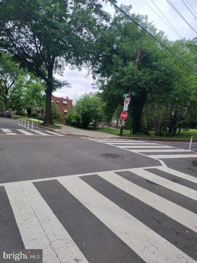4202 Grant St NE Unit 202, Washington, DC 20019 - view of asphalt street featuring traffic signs, sidewalks, curbs, and street lighting