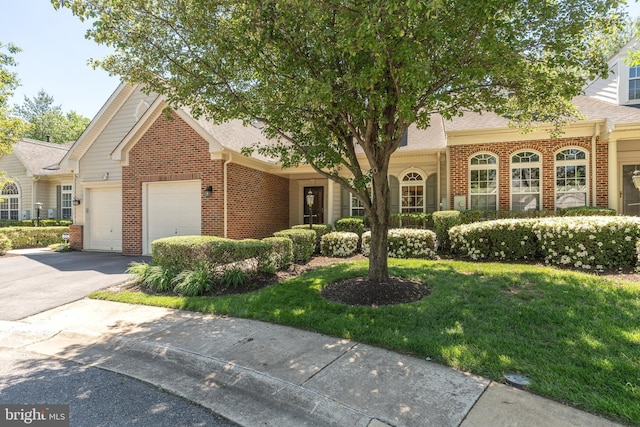 1908 Golden Morning Dr Unit 38, Bowie, MD 20721 - view of front of house with brick siding, asphalt driveway, roof with shingles, a front lawn, and an attached garage