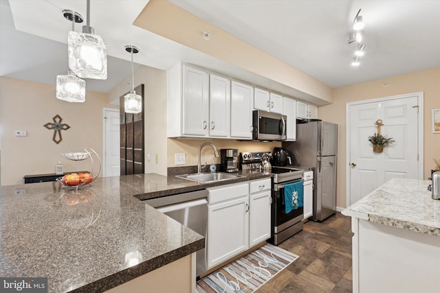 649 Brandon Rd, Eagleville, PA 19403 - kitchen featuring appliances with stainless steel finishes, a sink, stone finish floors, and white cabinets