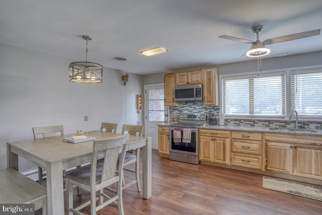 333 S School Ln, Smyrna, DE 19977 - kitchen featuring appliances with stainless steel finishes, a sink, tasteful backsplash, and healthy amount of natural light