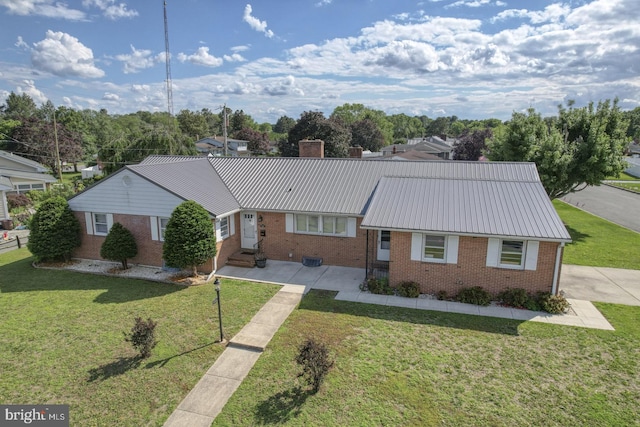 333 S School Ln, Smyrna, DE 19977 - ranch-style home featuring brick siding, entry steps, a chimney, and a front lawn