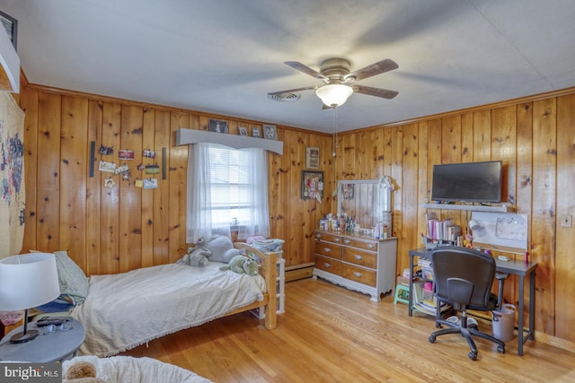 333 S School Ln, Smyrna, DE 19977 - bedroom with wood finished floors, wood walls, a baseboard heating unit, and an office area