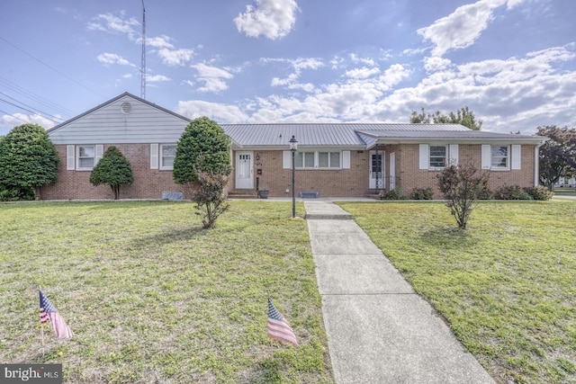 333 S School Ln, Smyrna, DE 19977 - single story home with brick siding, a front lawn, and metal roof