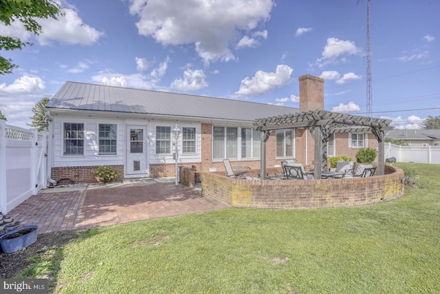 333 S School Ln, Smyrna, DE 19977 - back of house featuring a pergola, a patio area, a chimney, brick siding, and metal roof
