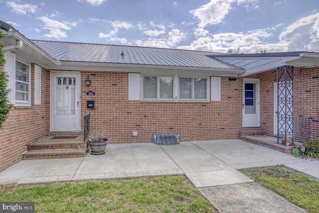 333 S School Ln, Smyrna, DE 19977 - property entrance featuring metal roof, brick siding, and crawl space