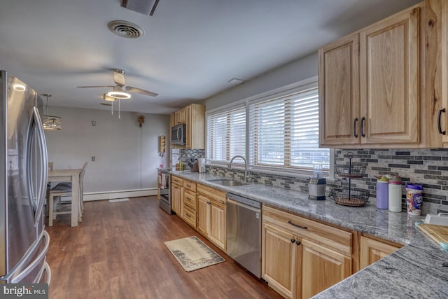 333 S School Ln, Smyrna, DE 19977 - kitchen featuring appliances with stainless steel finishes, a sink, light brown cabinets, and tasteful backsplash