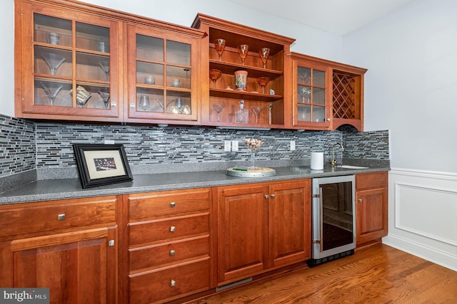 1430 Amherst Ct, Mechanicsburg, PA 17050 - bar area with wine cooler, wood finished floors, a wainscoted wall, a sink, and backsplash