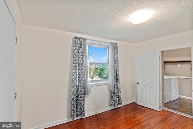 9615 51st Pl, College Park, MD 20740 - unfurnished bedroom featuring washer and dryer, wood finished floors, a textured ceiling, and baseboards
