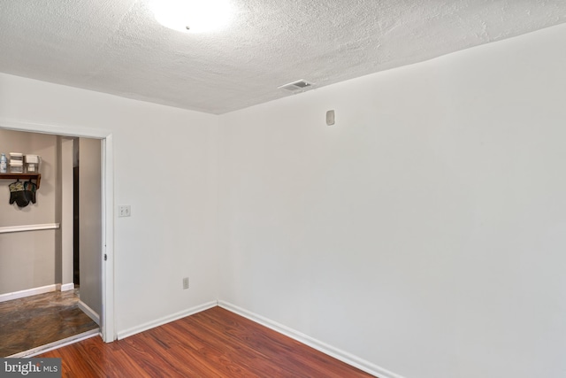 9615 51st Pl, College Park, MD 20740 - spare room with wood finished floors, a textured ceiling, and baseboards