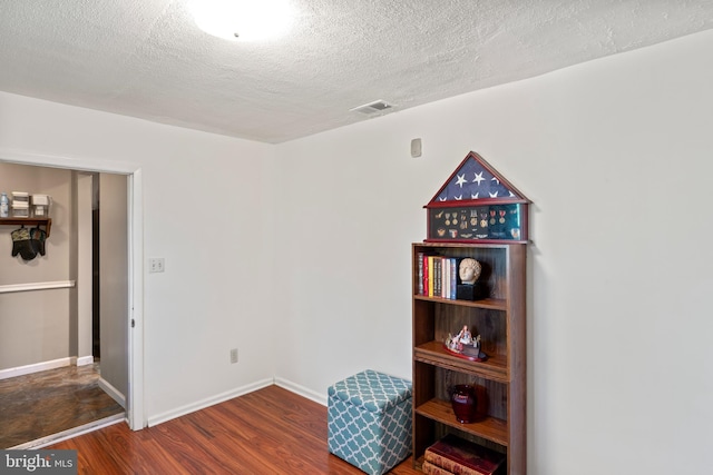 9615 51st Pl, College Park, MD 20740 - misc room featuring wood finished floors, a textured ceiling, and baseboards