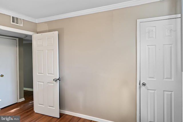 9615 51st Pl, College Park, MD 20740 - unfurnished bedroom featuring ornamental molding, wood finished floors, and baseboards