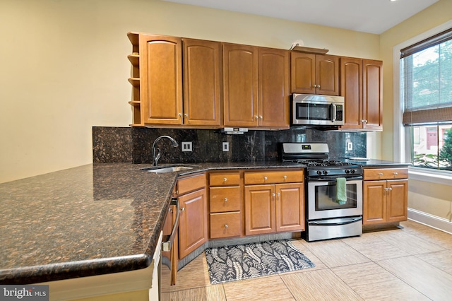 1812 Fairmount Ave, Philadelphia, PA 19130 - kitchen featuring stainless steel appliances, open shelves, backsplash, and brown cabinetry