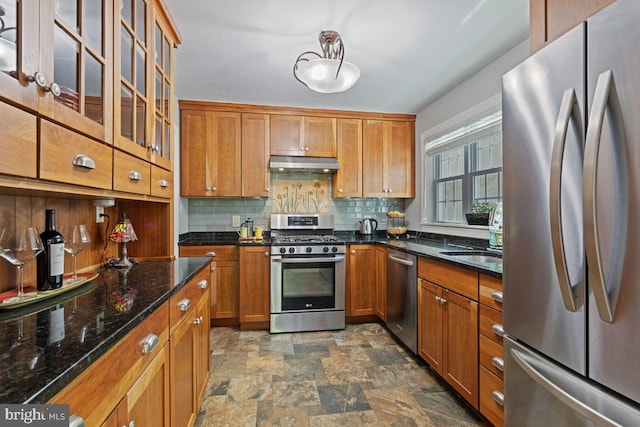 20 Oberlin Ave, Swarthmore, PA 19081 - kitchen featuring stainless steel appliances, under cabinet range hood, stone finish floors, decorative backsplash, and brown cabinets