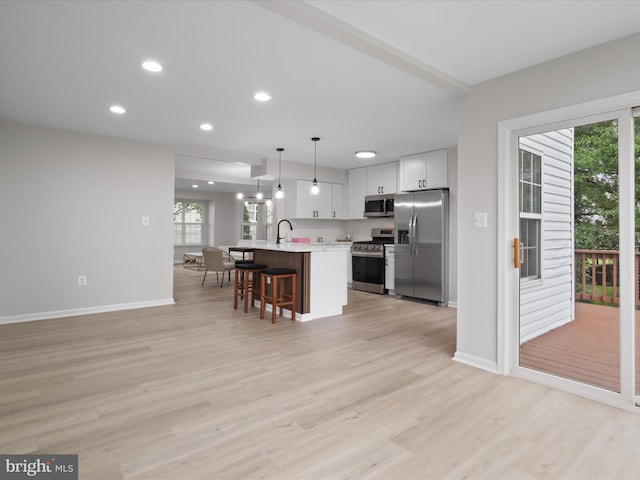 14282 Newbern Loop, Gainesville, VA 20155 - kitchen with stainless steel appliances, light countertops, plenty of natural light, a breakfast bar area, and recessed lighting