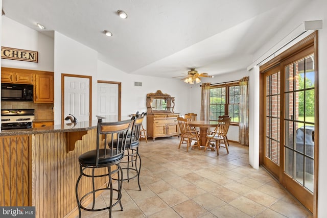 25 Warm Breeze Ct, Hanover, PA 17331 - kitchen featuring range with gas cooktop, black microwave, a breakfast bar area, backsplash, and a ceiling fan