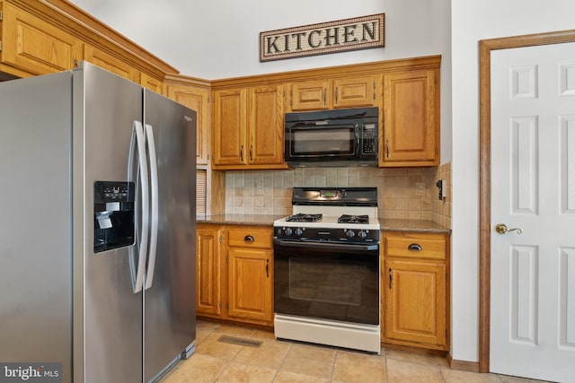 25 Warm Breeze Ct, Hanover, PA 17331 - kitchen featuring stainless steel fridge with ice dispenser, gas range oven, black microwave, backsplash, and brown cabinetry