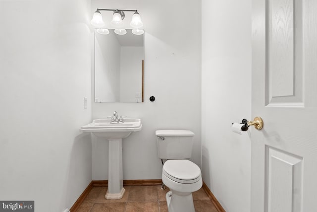 25 Warm Breeze Ct, Hanover, PA 17331 - half bathroom featuring toilet, baseboards, and a sink
