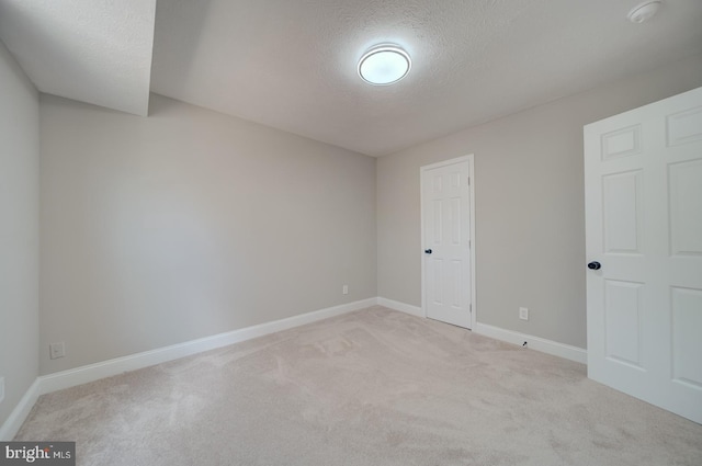 8250 Doewood Rd, Lusby, MD 20657 - unfurnished bedroom with a textured ceiling, light carpet, and baseboards