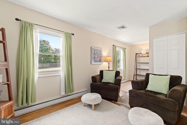 559 Schenely Ave, King Of Prussia, PA 19406 - living area featuring baseboard heating, plenty of natural light, and wood finished floors