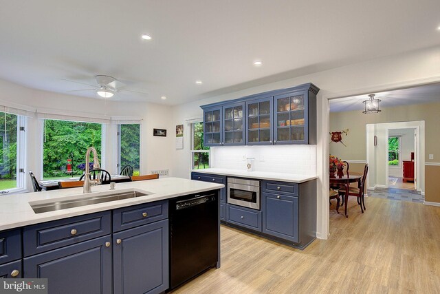 2119 Saint Heather Ln, Gambrills, MD 21054 - kitchen with black dishwasher, a sink, light wood-style flooring, light countertops, and recessed lighting