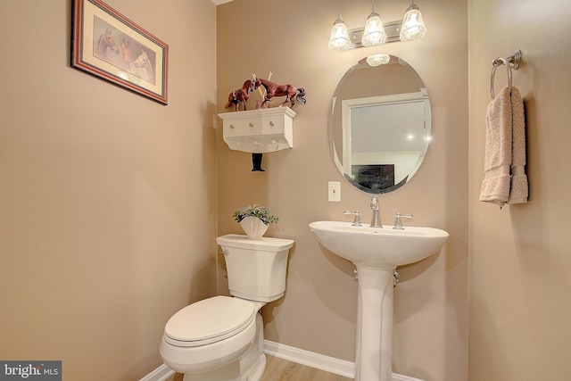 2119 Saint Heather Ln, Gambrills, MD 21054 - half bathroom with toilet, baseboards, and wood finished floors